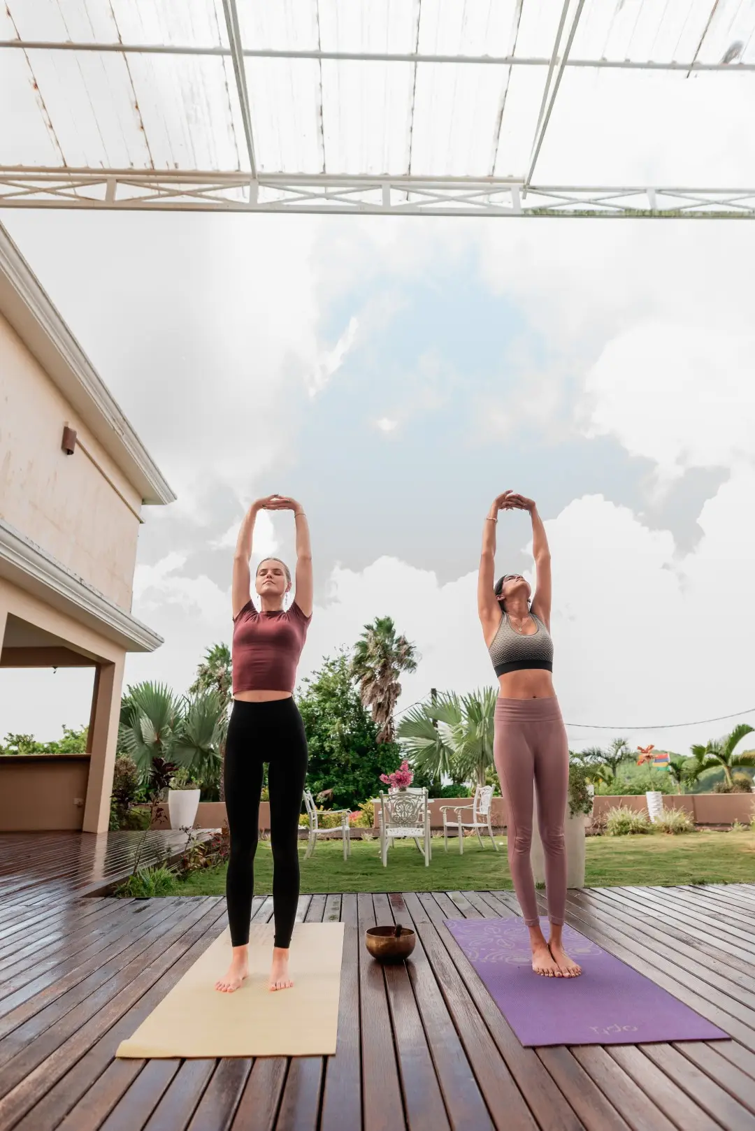 Two guests practising yoga outdoors at Olive Creek Wellness in Mauritius