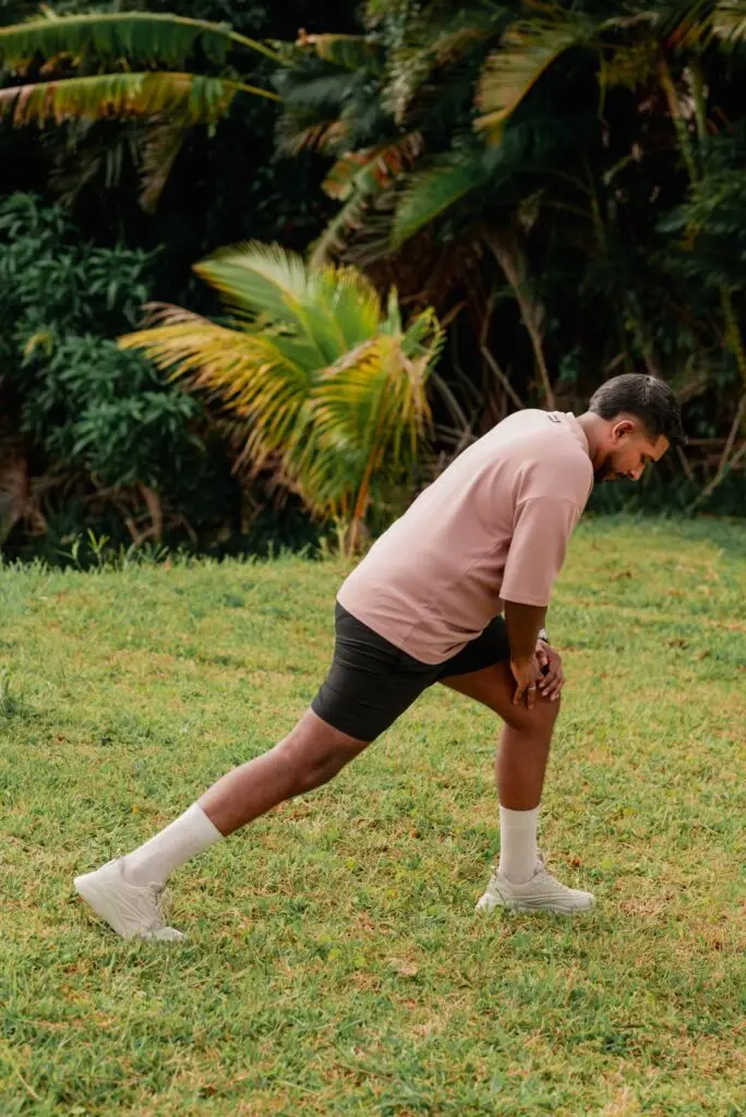 Guest performing a guided lunge and mobility exercise outdoors