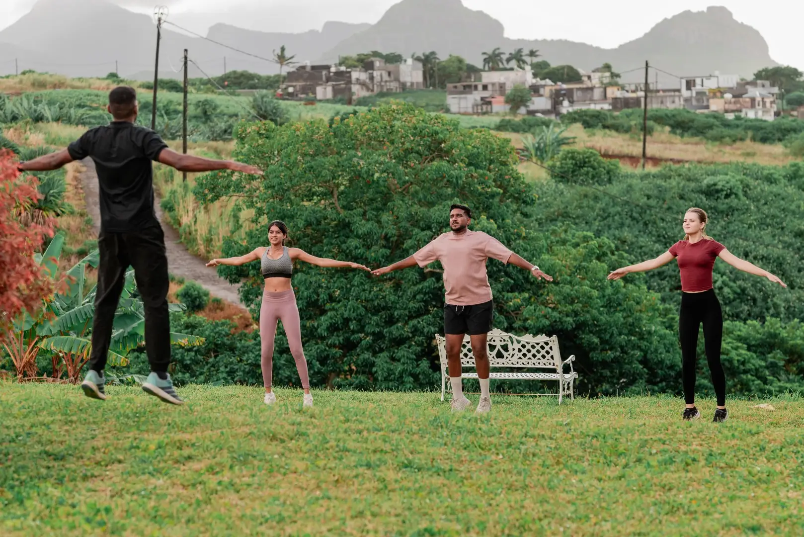 Small group stretching outdoors during a wellness retreat in Mauritius