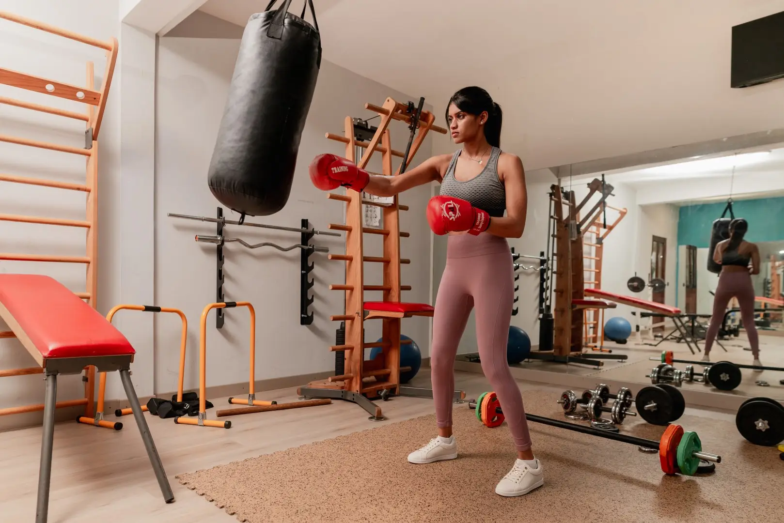 Woman completing a guided strength workout at Olive Creek Wellness