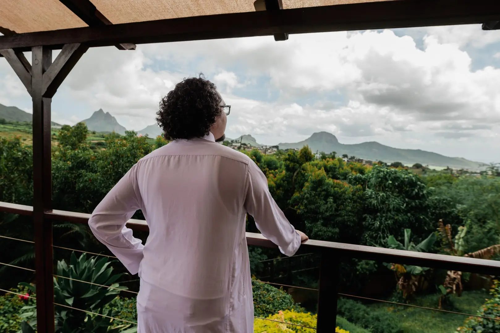 Man taking in the countryside views from a private retreat balcony