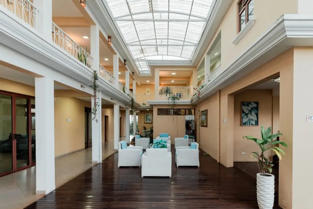 Bright indoor courtyard and guest walkway at Olive Creek Wellness