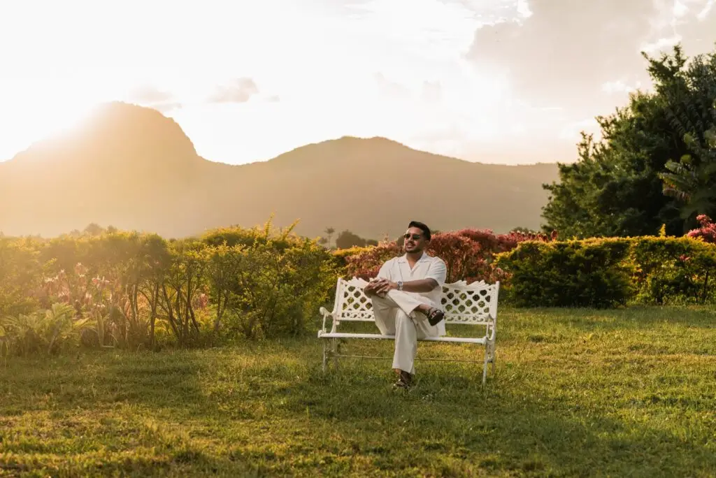 Guest resting outdoors with mountain views during a wellness retreat in Mauritius