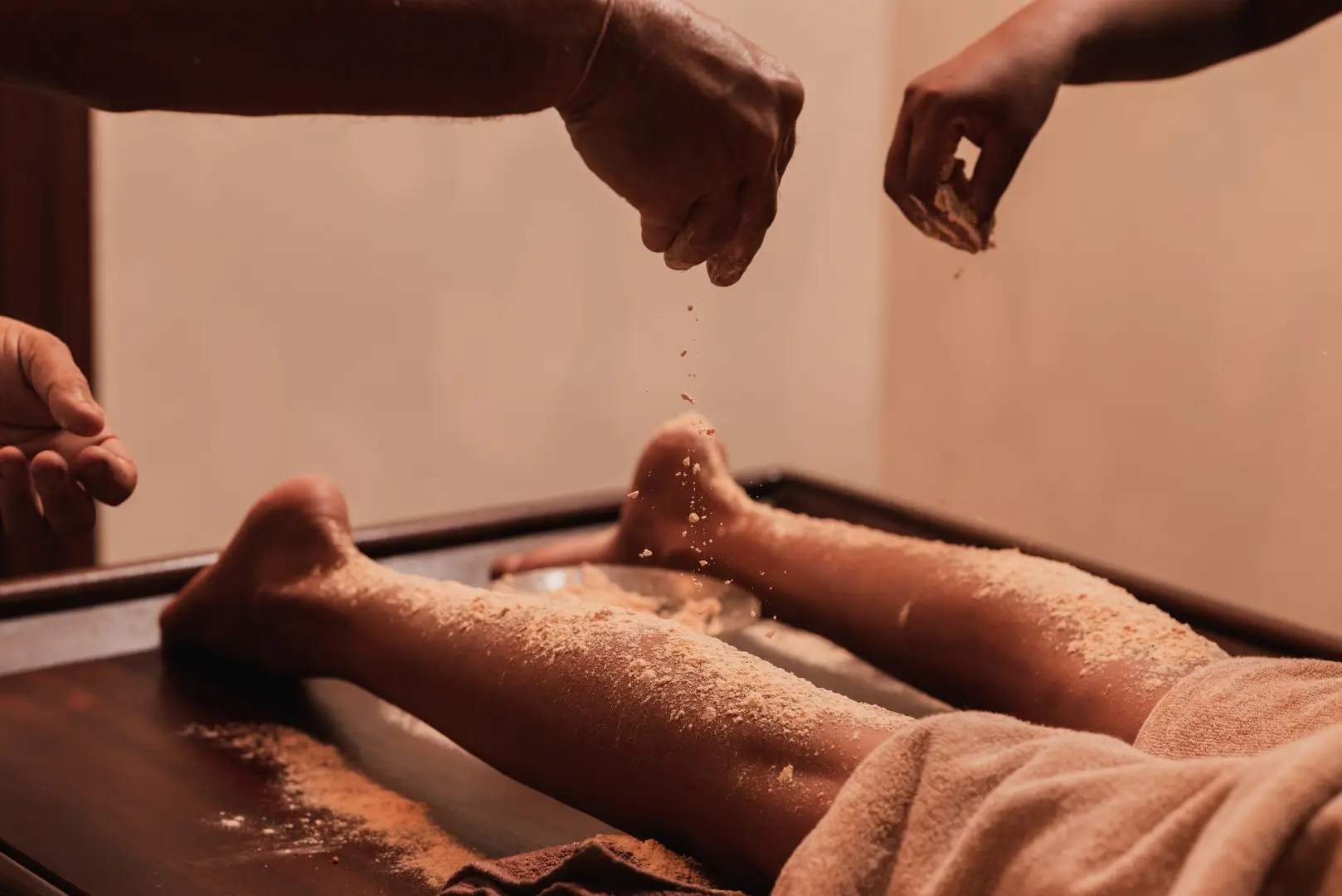 Therapist applying warm oil during an Ayurvedic foot treatment
