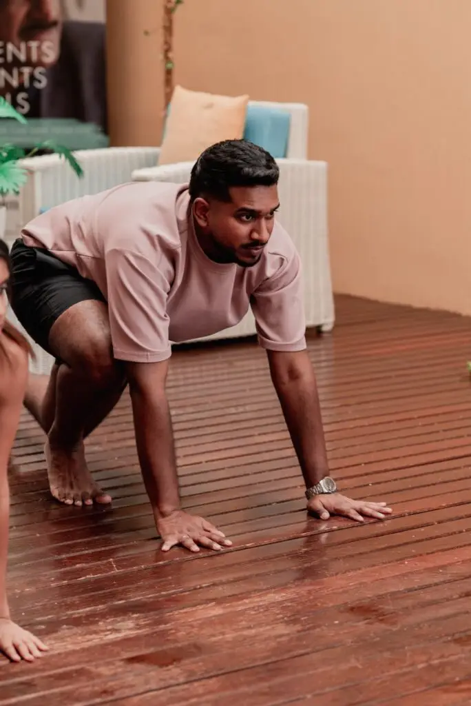 Man demonstrating a plank position during a fitness session