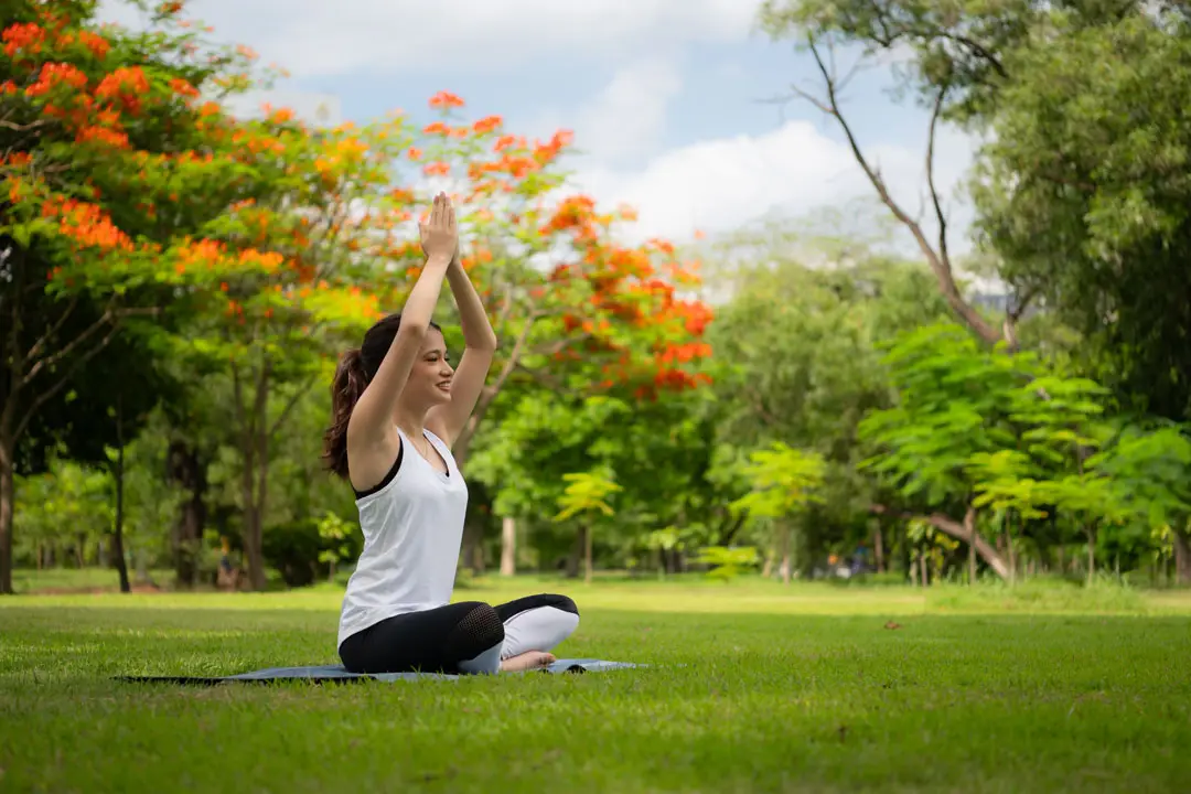 Woman enjoying mindful movement in a tropical garden